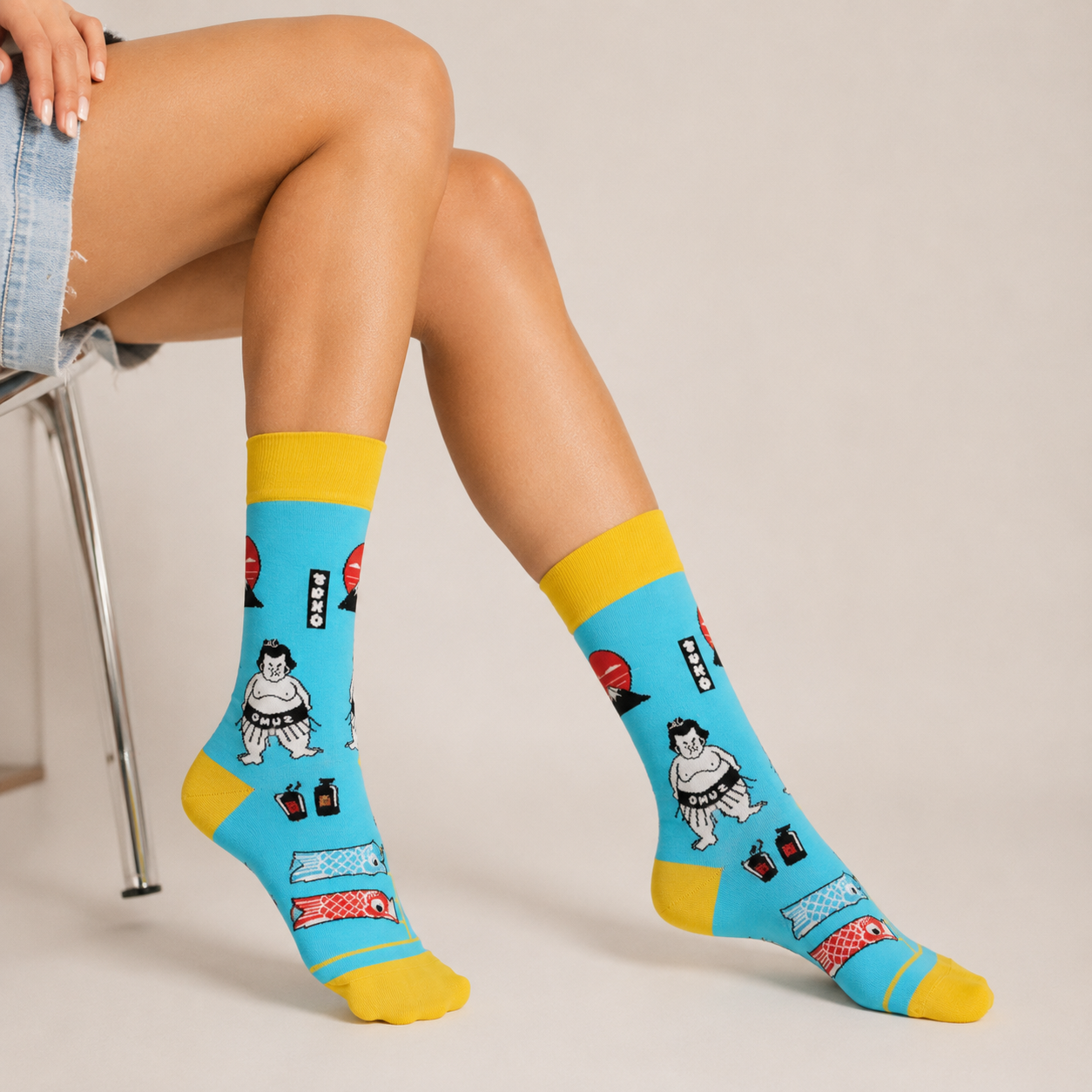 Pair of blue socks with cartoon designs on a beige background