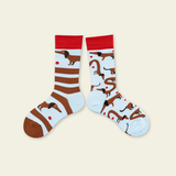 Two socks with dachshund dog patterns on a beige background