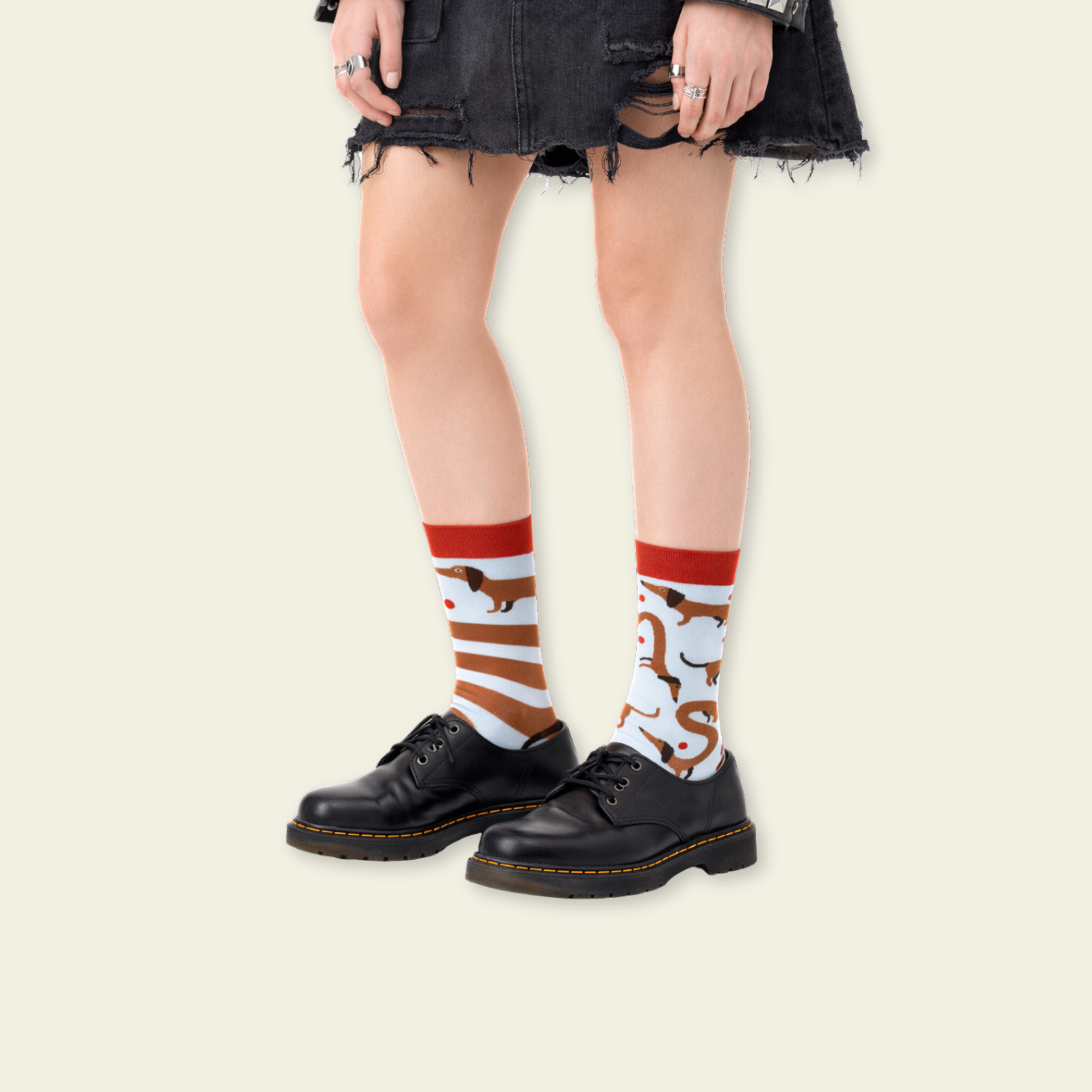 Person wearing black shoes and colorful socks with a white background