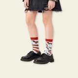 Person wearing black shoes and colorful socks with a white background
