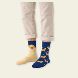 Person wearing blue socks with dog patterns on a plain background