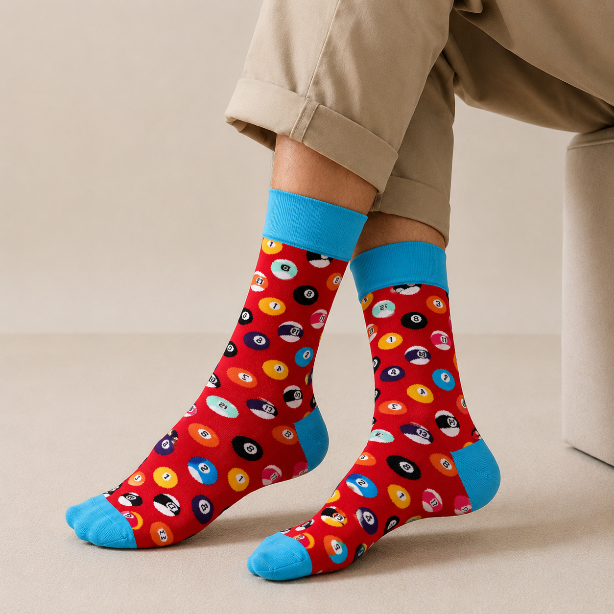 Colorful patterned socks with blue toes worn by a person on a beige background