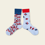 Two pairs of socks with colorful patterns on a beige background