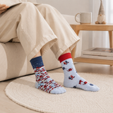 Person wearing patterned socks sitting on a couch in a cozy living room.