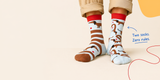 Person wearing patterned socks with a minimal background