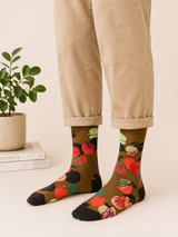 Person wearing floral socks with beige pants on a light background